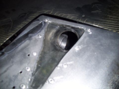 1995 Ford Probe - A close-up view of an unidentified automotive part shows a circular opening and metal construction.