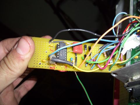 1993 Ford Probe - A close-up view of a circuit board with an integrated circuit and numerous colorful wires connected.