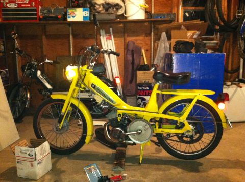 1981 Garelli Rally Sport - A yellow moped is parked in a garage next to another moped, with tools and boxes around.