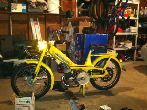 1981 Garelli Rally Sport - A yellow moped is parked in a cluttered garage next to another green moped.