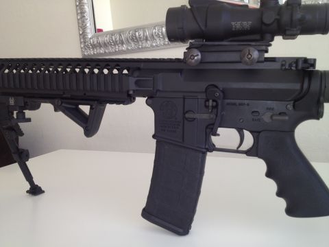 2013 Ford Mustang - Close-up of an AR-15 style rifle, a scope and bipod.