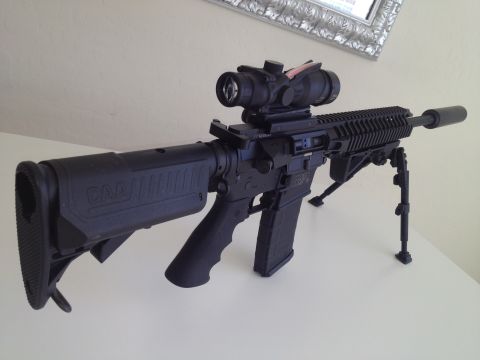 2013 Ford Mustang - AR-15 style rifle with aftermarket stock, optic, and bipod.