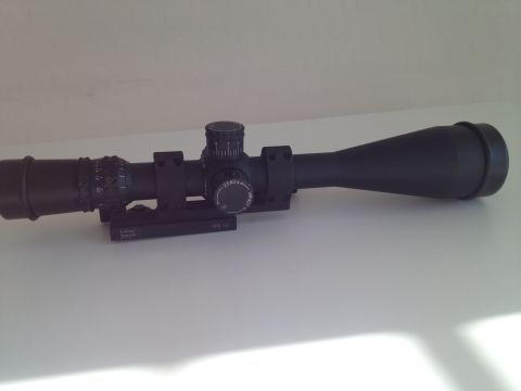 2013 Ford Mustang - A close-up view of a rifle scope, showing its various adjustment turrets and markings.