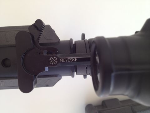 2013 Ford Mustang - A close-up view of a firearm's charging handle, the Noveske brand markings.