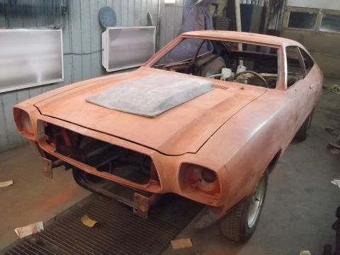 1978 Ford Mustang II - This car, possibly a 1974 Ford Mustang II, is undergoing bodywork in a garage.