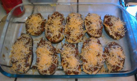 1989 Ford Bronco - Ten halves of eggplant, filled with a meat mixture and topped with shredded cheese, are arranged in a clear glass baking dish.