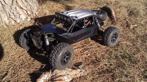 1996 Ford Bronco - This RC buggy has a roll cage and light bar on the roof, with large off-road tires.