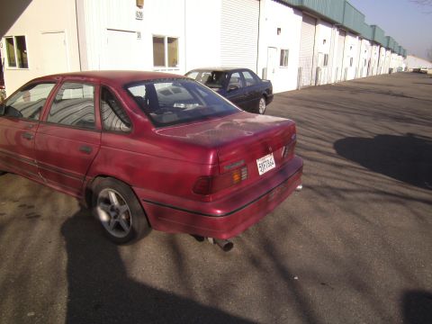 1991 Ford Taurus - This 1991 Ford Taurus sedan is seen from the rear in a parking lot.