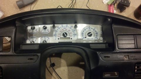 1995 Ford Bronco - The instrument cluster features white-faced gauges and a digital odometer display.