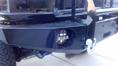 1995 Ford Bronco - Aftermarket bumper with PIAA lights and a tow hook is visible.