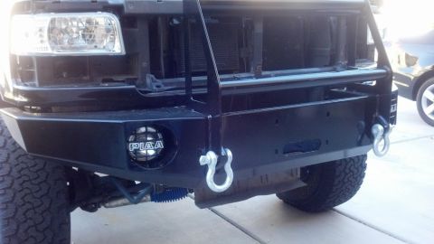 1995 Ford Bronco - Front view of a black Ford Bronco with an aftermarket bumper and tow hooks.