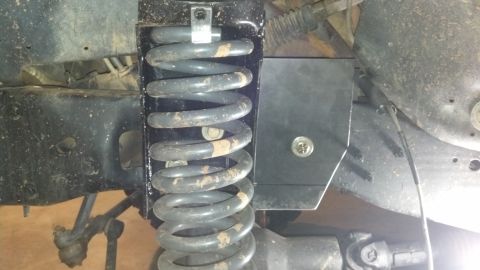 1992 Ford Bronco - This photo shows a modified coil bucket and suspension spring on a vehicle's chassis.