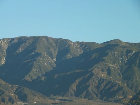2003 Ford Crown Victoria - Telephoto landscape of a furrowed mountain ridge in shadow with deep canyons and a faint valley below