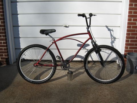 1994 Ford Bronco - A red cruiser bicycle is parked in front of a garage door.