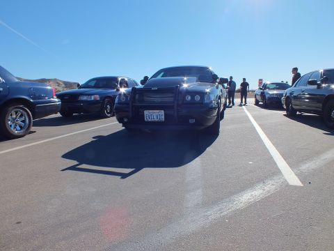 2003 Ford Crown Victoria - EVIL VIC Charger centered in a lot with sedans and bystanders behind
