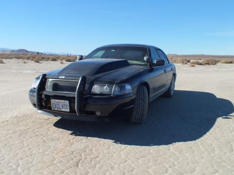 2003 Ford Crown Victoria - Black Crown Victoria with chrome brush guard and reversed black hood, California plate reading EVIL VIC.