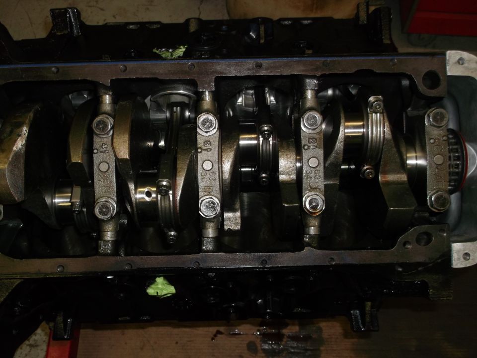Engine block with crankshaft and connecting rods visible, some with stamped numbers