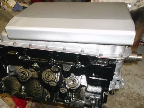 1965 Shelby Cobra - Engine block and oil pan assembly, likely for a classic car, with visible bolts and mounting points.