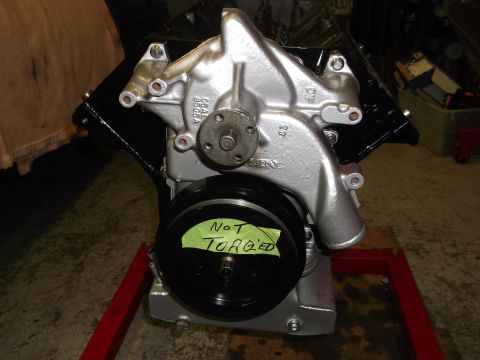 1965 Shelby Cobra - A silver engine water pump assembly is shown with a handwritten note indicating it is not torqued.