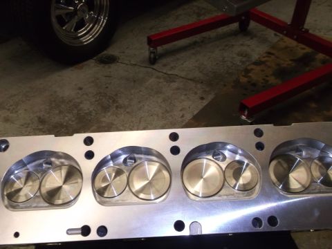 1965 Shelby Cobra - A close-up view of an engine cylinder head, showing the machined valve seats and ports.