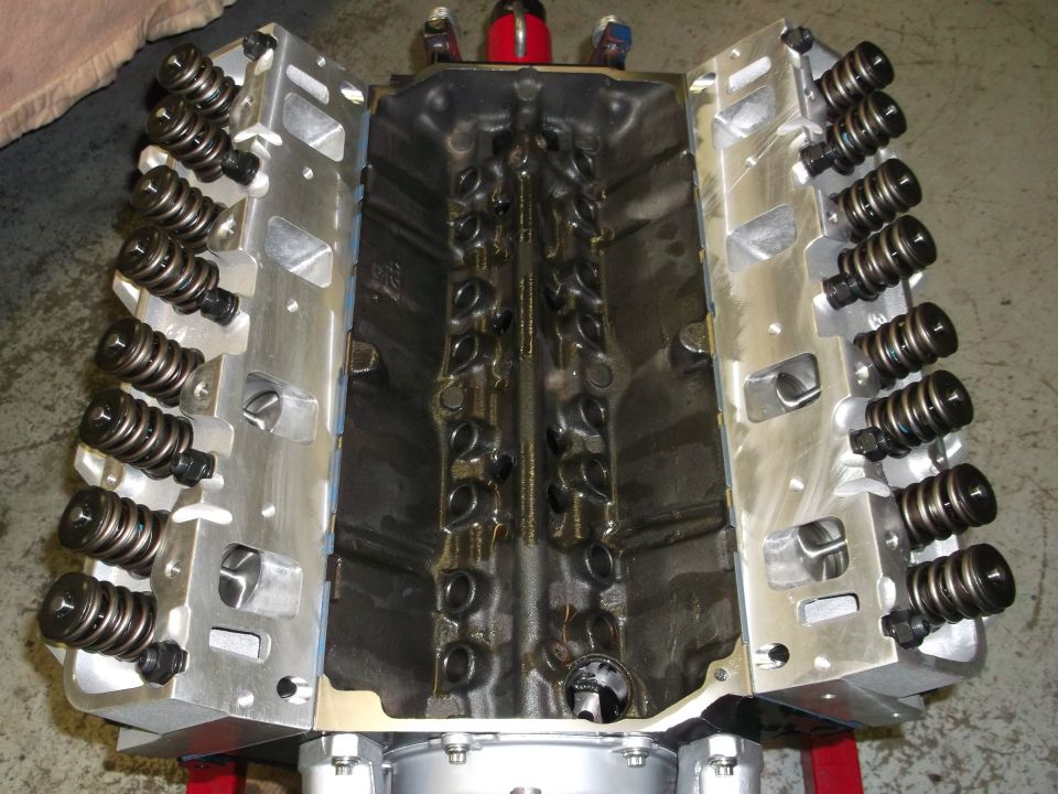 V8 engine block with aluminum cylinder heads and valve springs visible