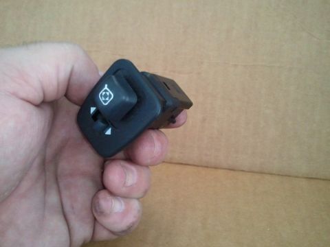 1994 Ford Bronco - A hand holds a power mirror control switch with directional indicators and a mirror symbol.