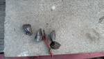 1996 Ford F-150 - Several small metal components are scattered on a textured concrete surface.