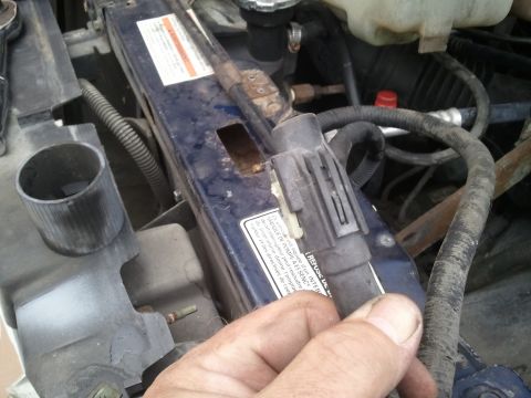 1994 Ford Bronco - Detail of an engine bay component, showing a label and electrical connector.