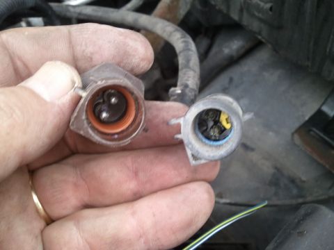 1994 Ford Bronco - Two electrical connectors are shown, one with an orange seal and the other with a blue seal and yellow wire.