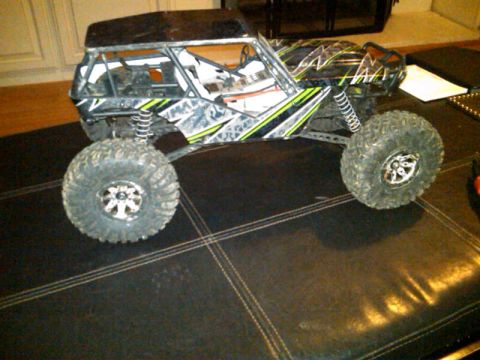 1986 Ford Bronco - This remote control rock crawler features a roll cage and aggressive off-road tires, captured in a side profile.