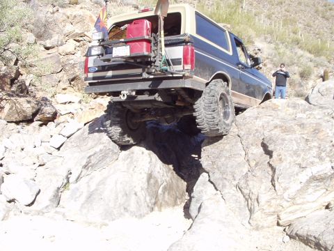 1993 Ford Bronco - Ford Bronco tackling a challenging rocky terrain, showing its off-road capabilities.