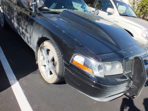 2003 Ford Crown Victoria - Front quarter of a black Crown Victoria with amber turn signal and steel push bumper.