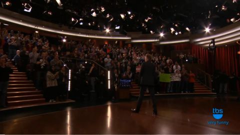 1993 Ford Taurus - A performer enters a studio audience area with a TBS logo in the corner.