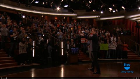 1993 Ford Taurus - A crowd of people are seated in a television studio, facing a stage area.