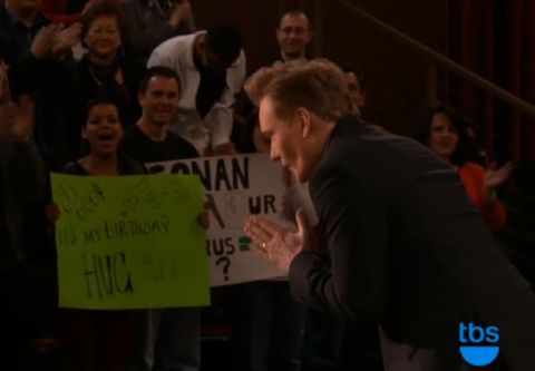 1993 Ford Taurus - Audience members hold signs for Conan O'Brien during a show taping.