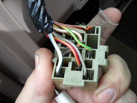 1994 Ford Bronco - Close-up of a Ford wiring harness connector with various colored wires connected.