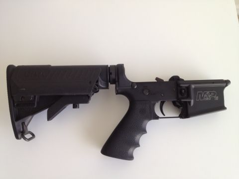 2013 Ford Mustang - A close-up view of an AR-15 lower receiver assembly, a CAA stock and M&P markings.