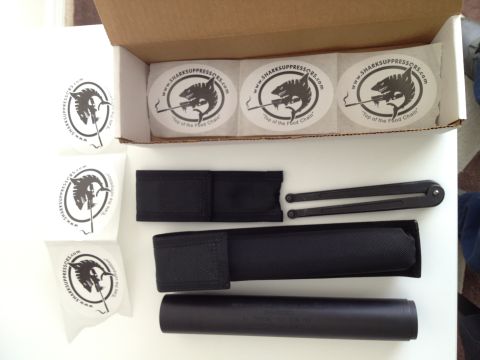 2013 Ford Mustang - A gun suppressor kit is laid out with multiple stickers and black fabric pouches.