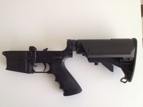 2013 Ford Mustang - This image shows a black AR-15 lower receiver with a CAA stock, a firearm component.