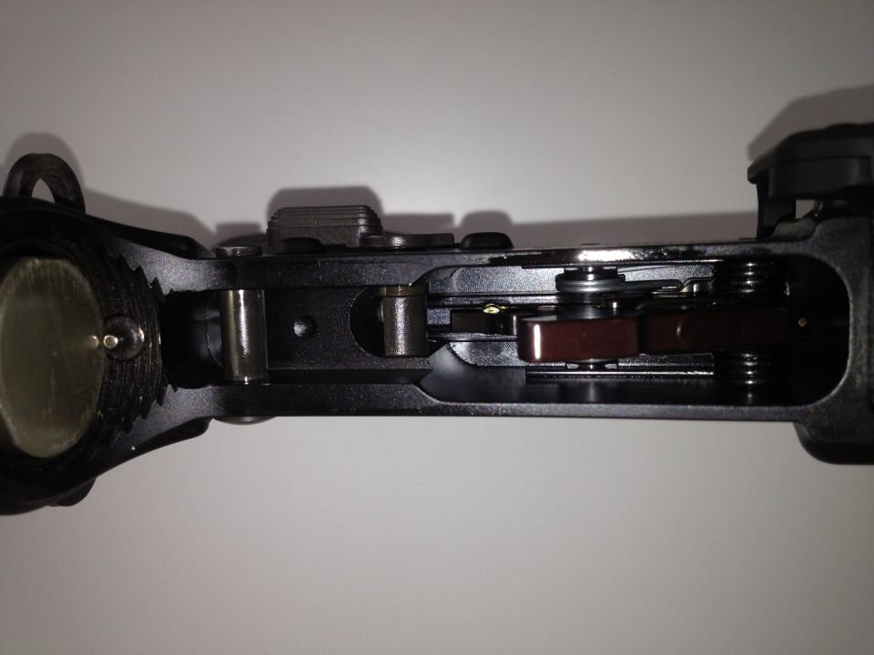 Close-up of a firearm's internal trigger mechanism with springs and levers