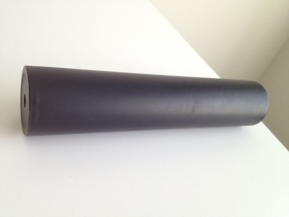 Black cylindrical exhaust tip on a white surface. Supermotors.net logo in the corner