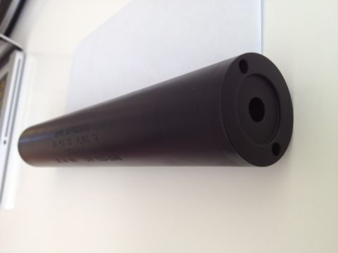 2013 Ford Mustang - A black suppressor with visible text and mounting holes is shown against a white background.