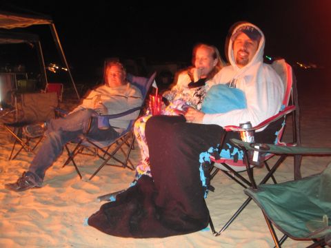 1989 Ford Bronco - People relax on the beach at night around a campfire.