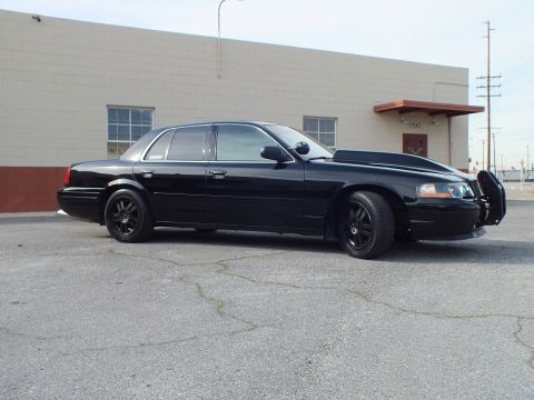 2003 Ford Crown Victoria - Front quarter view of a lowered blacked-out sedan fitted with a front push bar