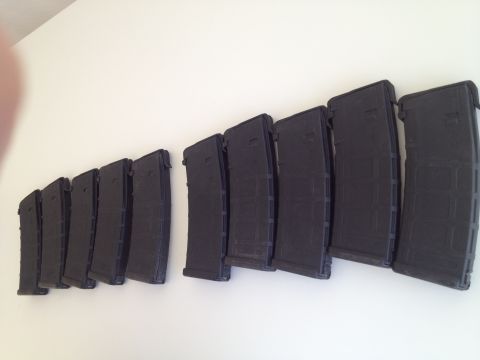 2013 Ford Mustang - A collection of firearm magazines are displayed against a plain white background.