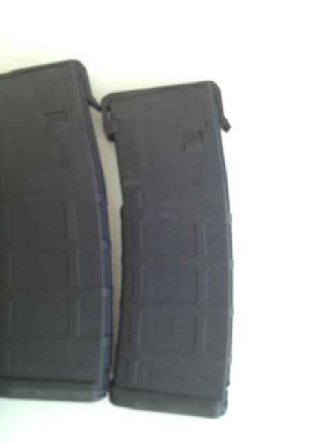 2013 Ford Mustang - Two black rifle magazines are shown against a white background.