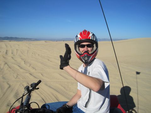 1989 Ford Bronco - Riding an ATV through the sand dunes under a clear blue sky.