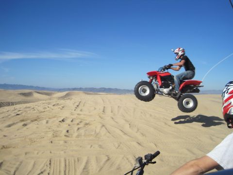 1989 Ford Bronco - Rider catches air on an ATV during a desert excursion.