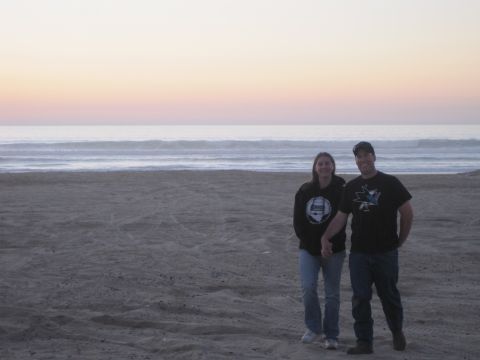 1989 Ford Bronco - A couple enjoys a moment on the beach as the sun sets over the ocean.