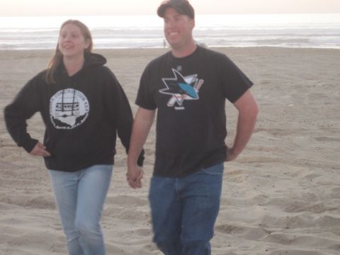 1989 Ford Bronco - Couple walks on the beach during daytime with the ocean in the background.